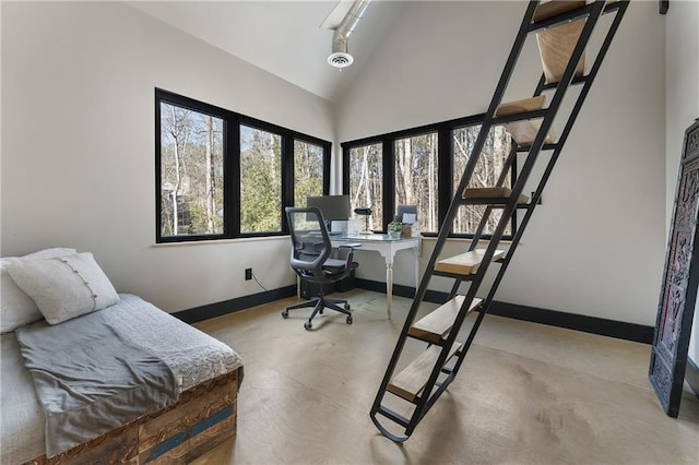 office space with concrete flooring and high vaulted ceiling