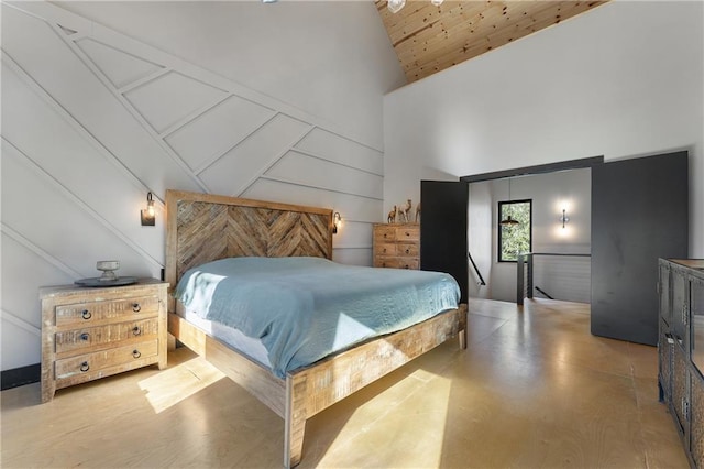 bedroom with wood ceiling and high vaulted ceiling