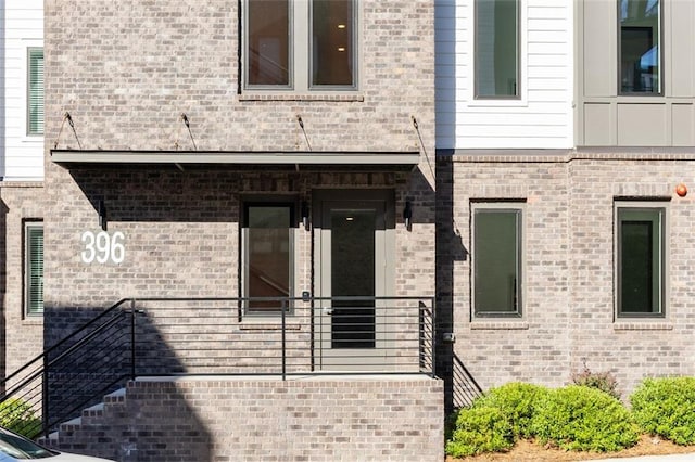 property entrance featuring brick siding