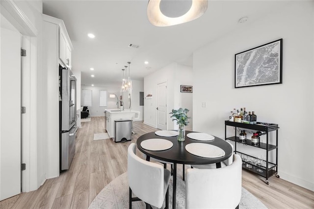 dining area with recessed lighting, visible vents, baseboards, and light wood-style flooring