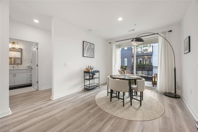 dining space with visible vents, recessed lighting, baseboards, and light wood finished floors