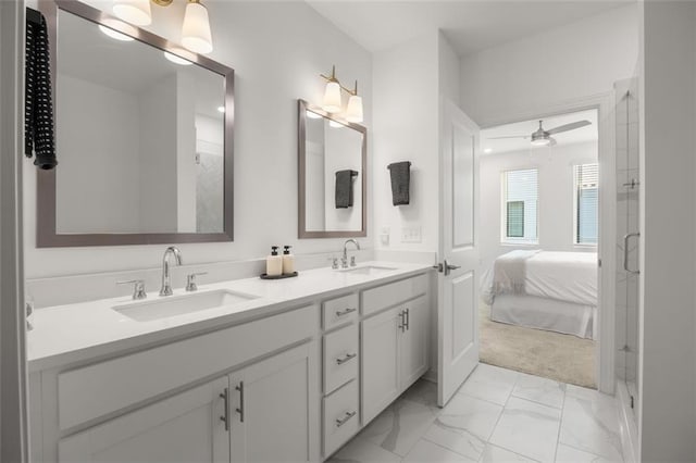 bathroom with a sink, marble finish floor, ceiling fan, and double vanity