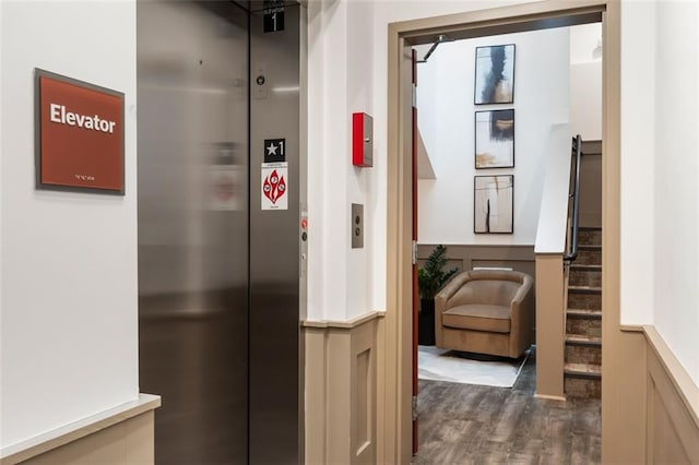 interior space featuring dark wood finished floors, stairway, and elevator