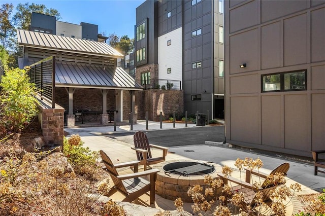 view of home's community featuring a patio and an outdoor fire pit