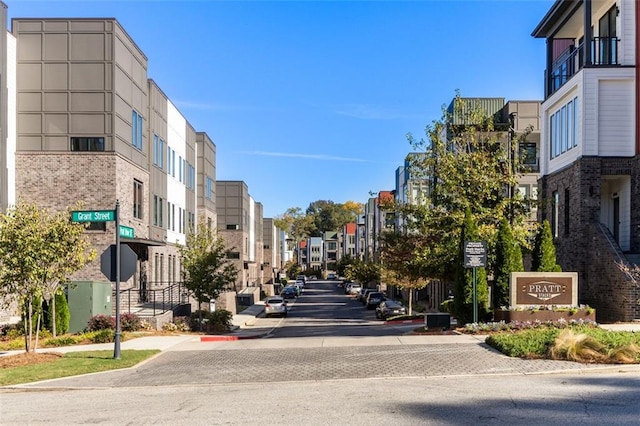 view of road with traffic signs, curbs, sidewalks, and a residential view