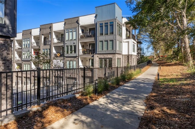 exterior space featuring a residential view and fence