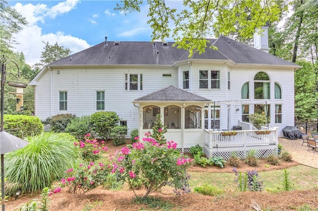 452 Brushstroke Ct SE, Marietta, GA 30067 - back of house with a chimney, a deck, and a shingled roof