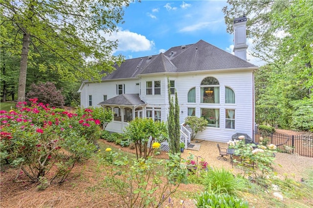 452 Brushstroke Ct SE, Marietta, GA 30067 - back of property featuring a sunroom and a chimney