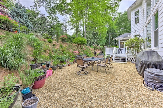 452 Brushstroke Ct SE, Marietta, GA 30067 - view of yard with a wooden deck, outdoor dining space, and view of wooded area