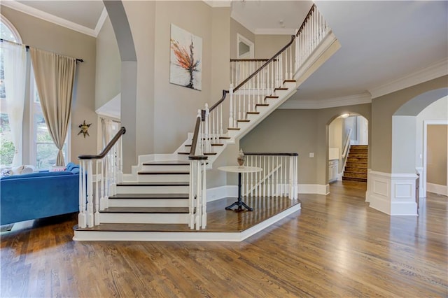 452 Brushstroke Ct SE, Marietta, GA 30067 - staircase with wood finished floors, arched walkways, ornamental molding, and baseboards