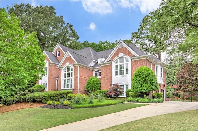 452 Brushstroke Ct SE, Marietta, GA 30067 - view of front facade featuring brick siding, a front lawn, and driveway