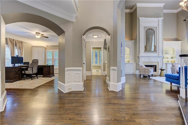452 Brushstroke Ct SE, Marietta, GA 30067 - foyer entrance with a ceiling fan, dark wood-style floors, arched walkways, a fireplace, and ornamental molding