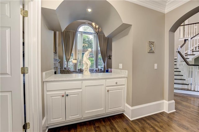 452 Brushstroke Ct SE, Marietta, GA 30067 - bar area with arched walkways, stairs, baseboards, dark wood-style floors, and crown molding