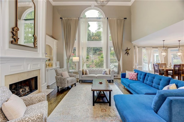 452 Brushstroke Ct SE, Marietta, GA 30067 - living area with a towering ceiling, healthy amount of natural light, wood finished floors, a fireplace, and ornamental molding