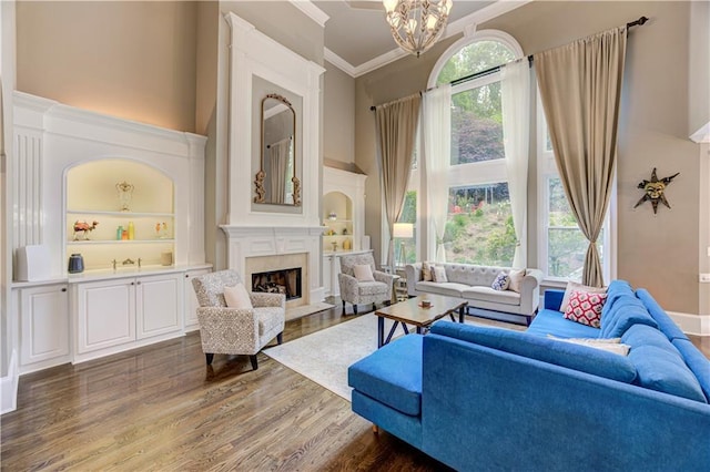 452 Brushstroke Ct SE, Marietta, GA 30067 - living area featuring a high ceiling, dark wood-type flooring, a high end fireplace, crown molding, and a chandelier