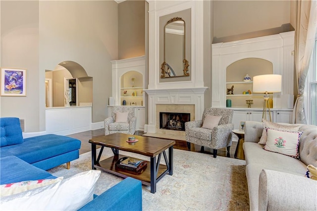 452 Brushstroke Ct SE, Marietta, GA 30067 - living room with a high ceiling, built in features, a high end fireplace, and baseboards