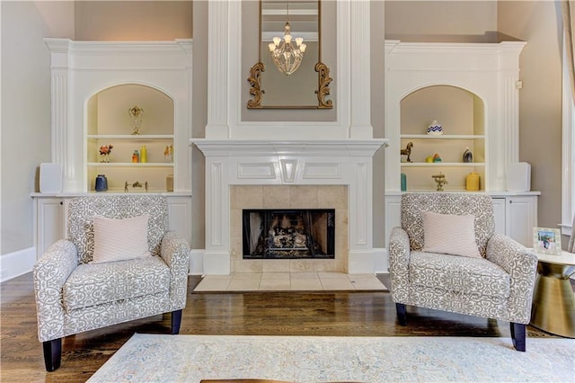 452 Brushstroke Ct SE, Marietta, GA 30067 - sitting room featuring built in features, wood finished floors, a tile fireplace, and baseboards