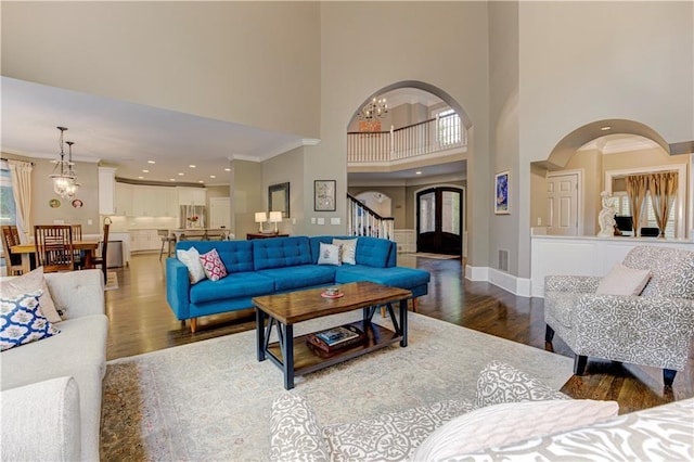452 Brushstroke Ct SE, Marietta, GA 30067 - living room with wood finished floors, ornamental molding, a high ceiling, baseboards, and stairway