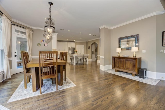 452 Brushstroke Ct SE, Marietta, GA 30067 - dining space featuring arched walkways, crown molding, wood finished floors, baseboards, and recessed lighting