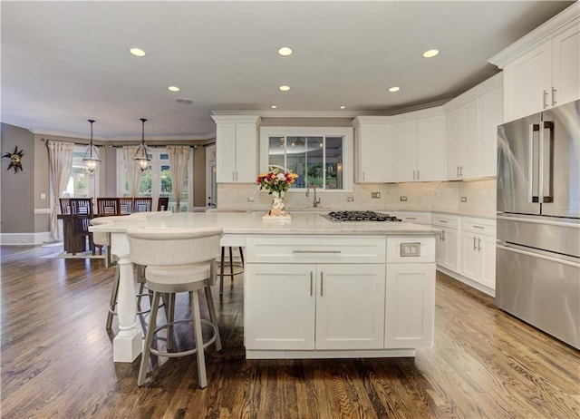 452 Brushstroke Ct SE, Marietta, GA 30067 - kitchen with high quality fridge, white cabinets, a sink, gas cooktop, and a center island
