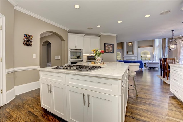 452 Brushstroke Ct SE, Marietta, GA 30067 - kitchen featuring stainless steel appliances, recessed lighting, a kitchen island, dark wood finished floors, and ornamental molding