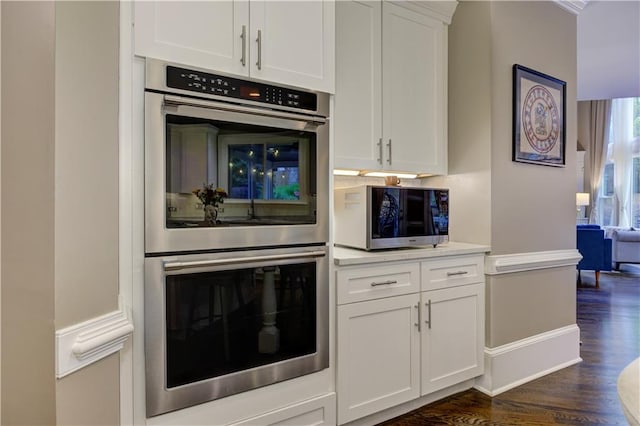 452 Brushstroke Ct SE, Marietta, GA 30067 - kitchen with stainless steel appliances, dark wood-type flooring, white cabinets, light countertops, and baseboards