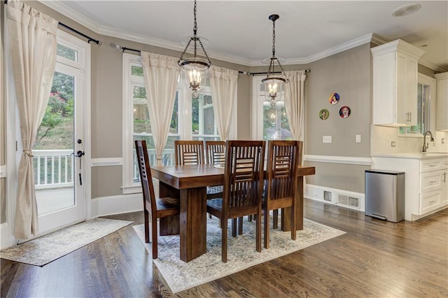 452 Brushstroke Ct SE, Marietta, GA 30067 - dining room featuring dark wood-style flooring, crown molding, a chandelier, and baseboards