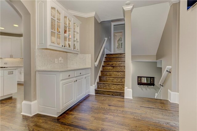 452 Brushstroke Ct SE, Marietta, GA 30067 - stairs featuring wood finished floors, ornamental molding, arched walkways, and recessed lighting