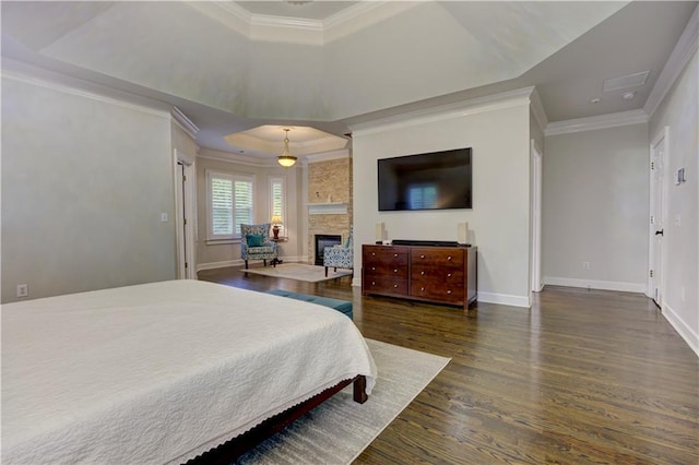 452 Brushstroke Ct SE, Marietta, GA 30067 - bedroom with a raised ceiling, wood finished floors, crown molding, baseboards, and a stone fireplace