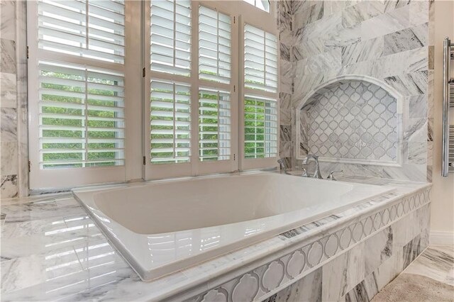 452 Brushstroke Ct SE, Marietta, GA 30067 - bathroom featuring a garden tub and marble finish flooring