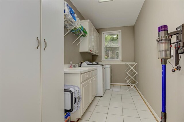 452 Brushstroke Ct SE, Marietta, GA 30067 - laundry area with cabinet space, washer and clothes dryer, light tile patterned floors, and baseboards