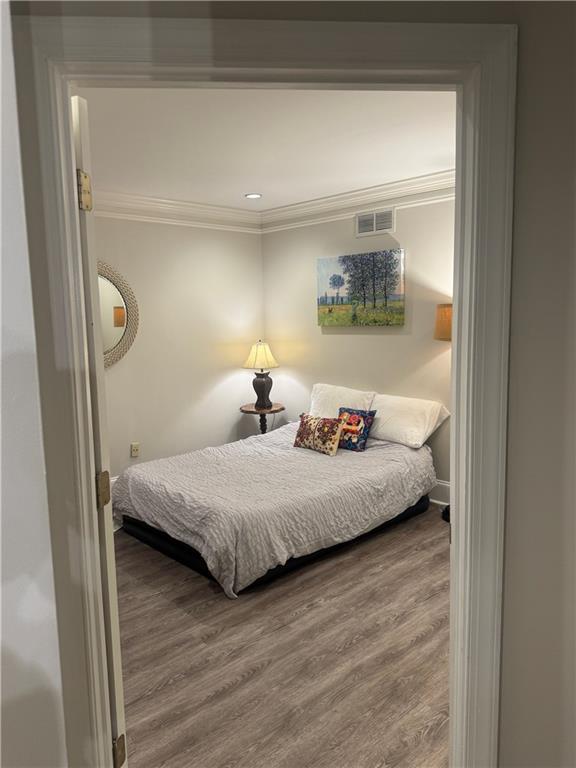 452 Brushstroke Ct SE, Marietta, GA 30067 - bedroom with ornamental molding, wood finished floors, and baseboards