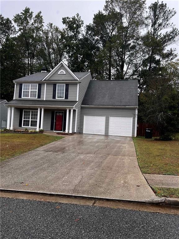 front facade with a garage and a front yard