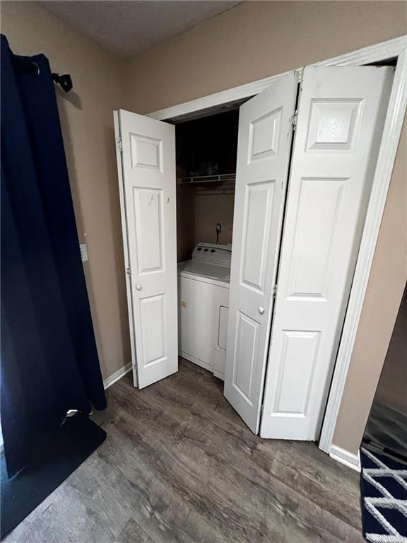 washroom with washer / clothes dryer and dark hardwood / wood-style flooring