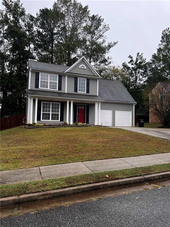 view of front of property with a garage and a front yard