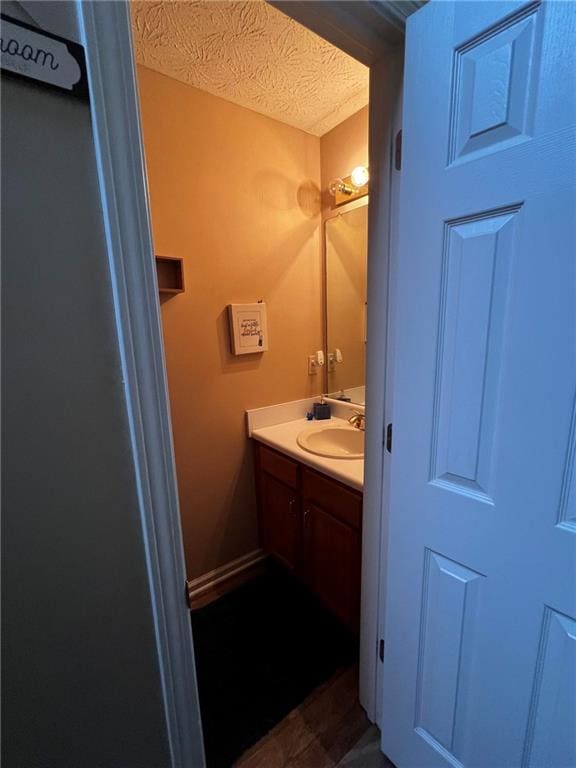 bathroom with a textured ceiling and vanity