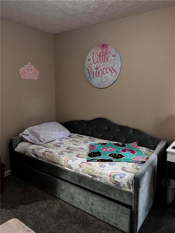 carpeted bedroom featuring a textured ceiling