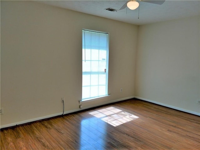 295 Forest Pl, Lawrenceville, GA 30046 - empty room with plenty of natural light, ceiling fan, and wood finished floors