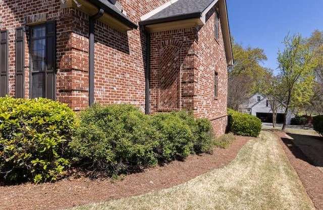 view of side of home with brick siding