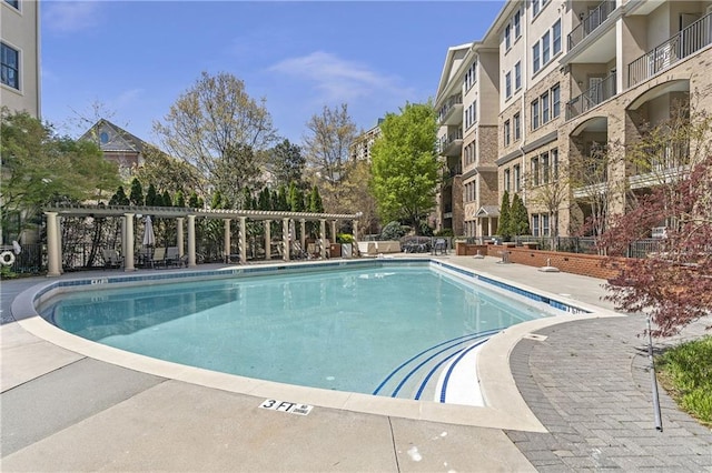 community pool with a pergola