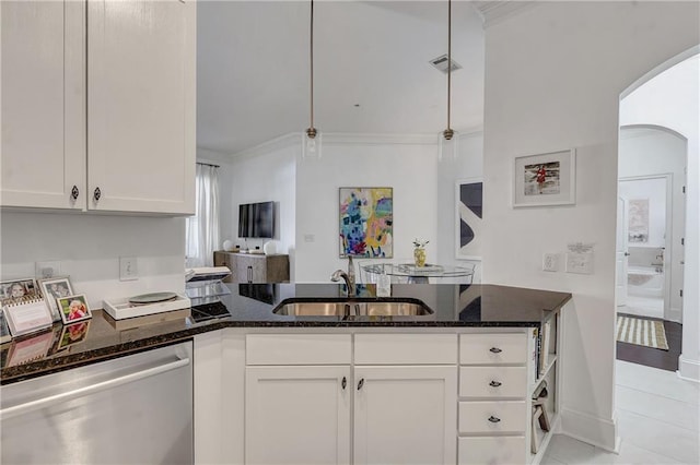 kitchen featuring dark stone countertops, visible vents, stainless steel dishwasher, arched walkways, and a sink