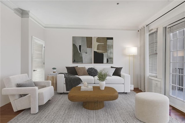 living room with wood finished floors and ornamental molding