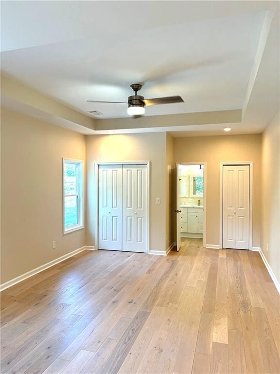 unfurnished bedroom with ceiling fan and light hardwood / wood-style floors