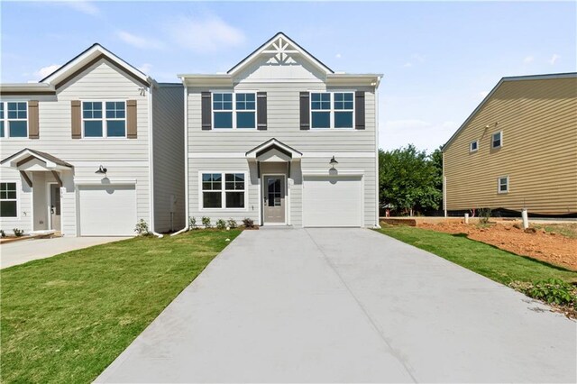 view of front of house featuring a front yard and a garage