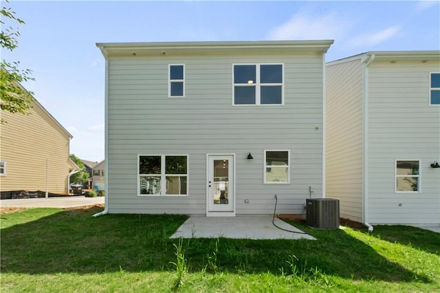 back of property featuring central air condition unit, a patio, and a yard