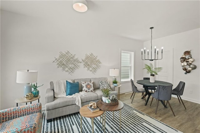 living room with light wood-type flooring and a chandelier