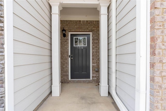 doorway to property with stone siding