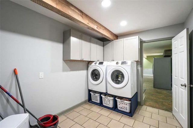 washroom featuring cabinets and washing machine and clothes dryer