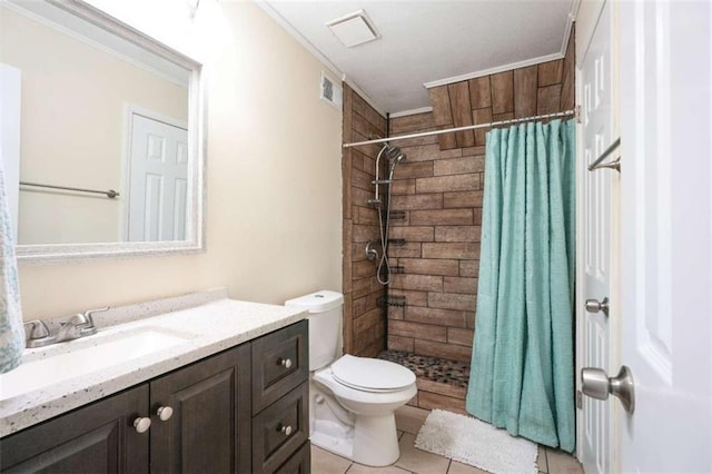 bathroom featuring toilet, crown molding, vanity, a shower with shower curtain, and tile patterned flooring