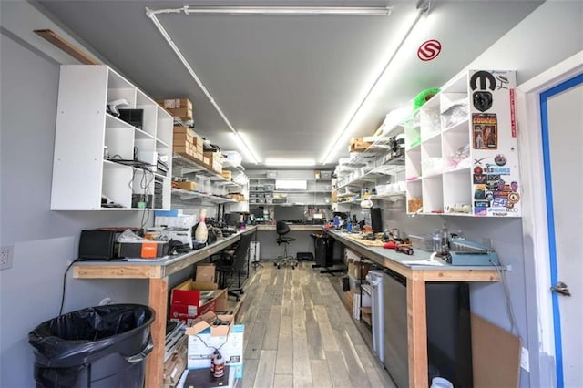 interior space with wood-type flooring and a workshop area